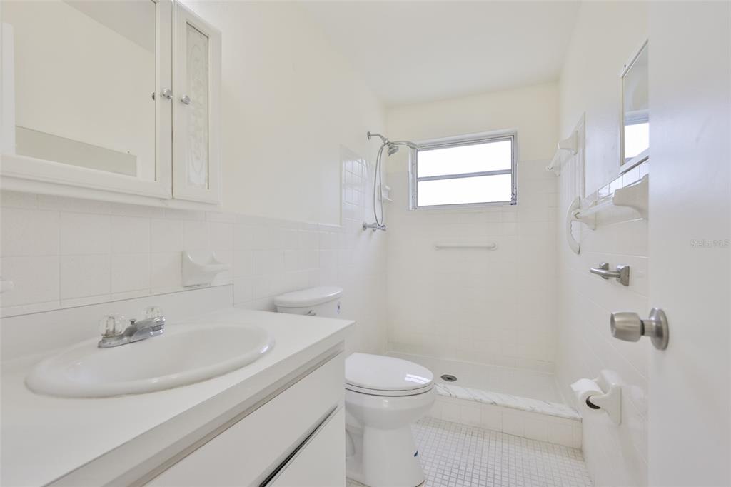 2358 Ecuadorian Way, Unit 56 Clearwater, FL 33763 - Photo 15 of 33 a bathroom with a sink a toilet and shower