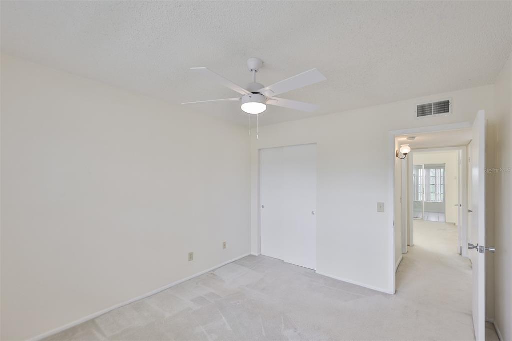 2358 Ecuadorian Way, Unit 56 Clearwater, FL 33763 - Photo 17 of 33 an empty room with closet and a ceiling fan
