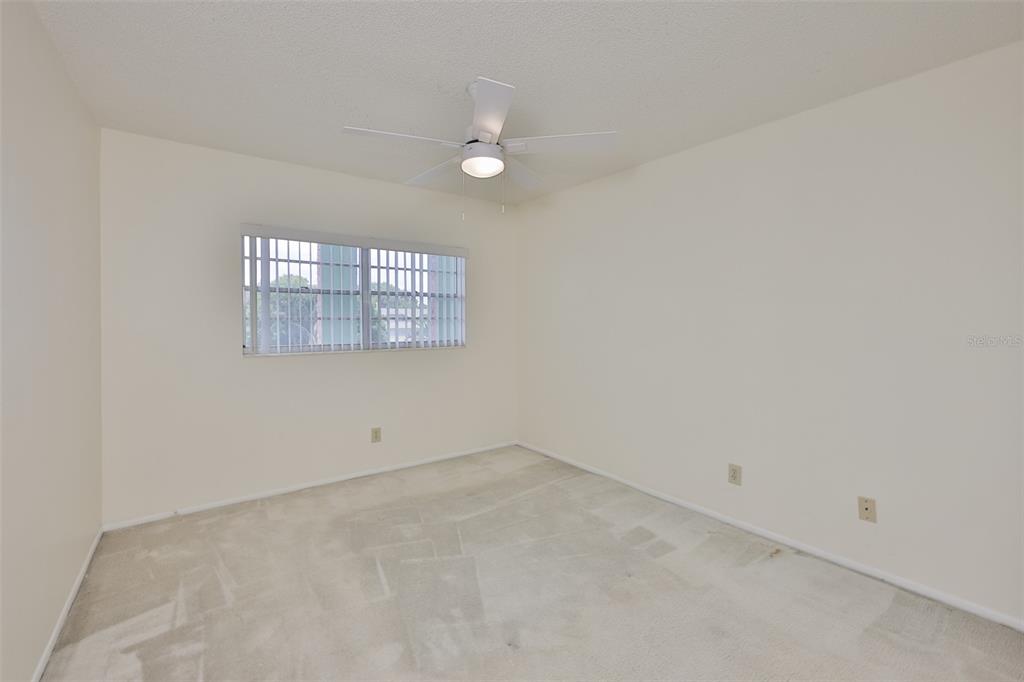 2358 Ecuadorian Way, Unit 56 Clearwater, FL 33763 - Photo 18 of 33 an empty room with a chandelier fan