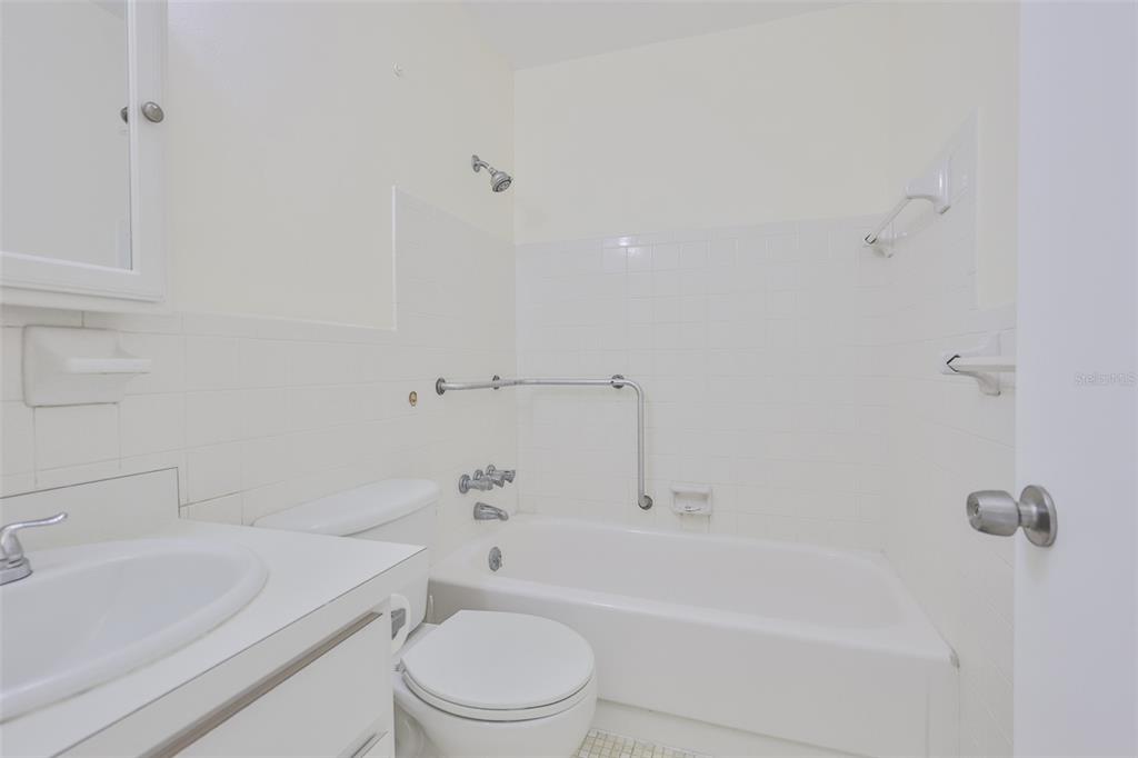 2358 Ecuadorian Way, Unit 56 Clearwater, FL 33763 - Photo 19 of 33 a bathroom with a sink a toilet and a bathtub