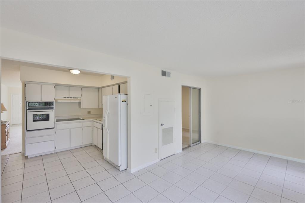 2358 Ecuadorian Way, Unit 56 Clearwater, FL 33763 - Photo 8 of 33 a kitchen with white cabinets and stainless steel appliances