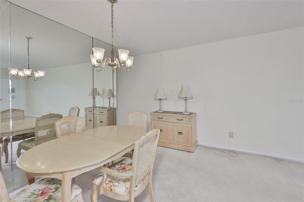 2358 Ecuadorian Way, Unit 56 Clearwater, FL 33763 - Photo 9 of 33 a very nice looking dining room with a table and chairs