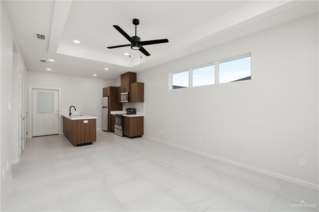 3501 Mary Lane, Unit 2 Weslaco, TX 78599 - Photo 3 of 10 a kitchen with stainless steel appliances a refrigerator and microwave