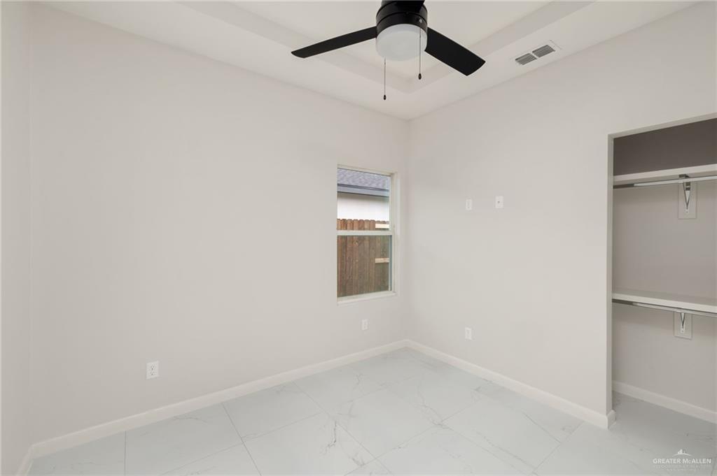 3501 Mary Lane, Unit 2 Weslaco, TX 78599 - Photo 8 of 10 an empty room with a empty space and a ceiling fan