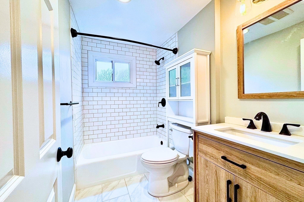 22 Beacon Avenue, Unit 3 Newburyport, MA 01950 - Photo 8 of 10 a bathroom with a sink toilet a shower and bathtub