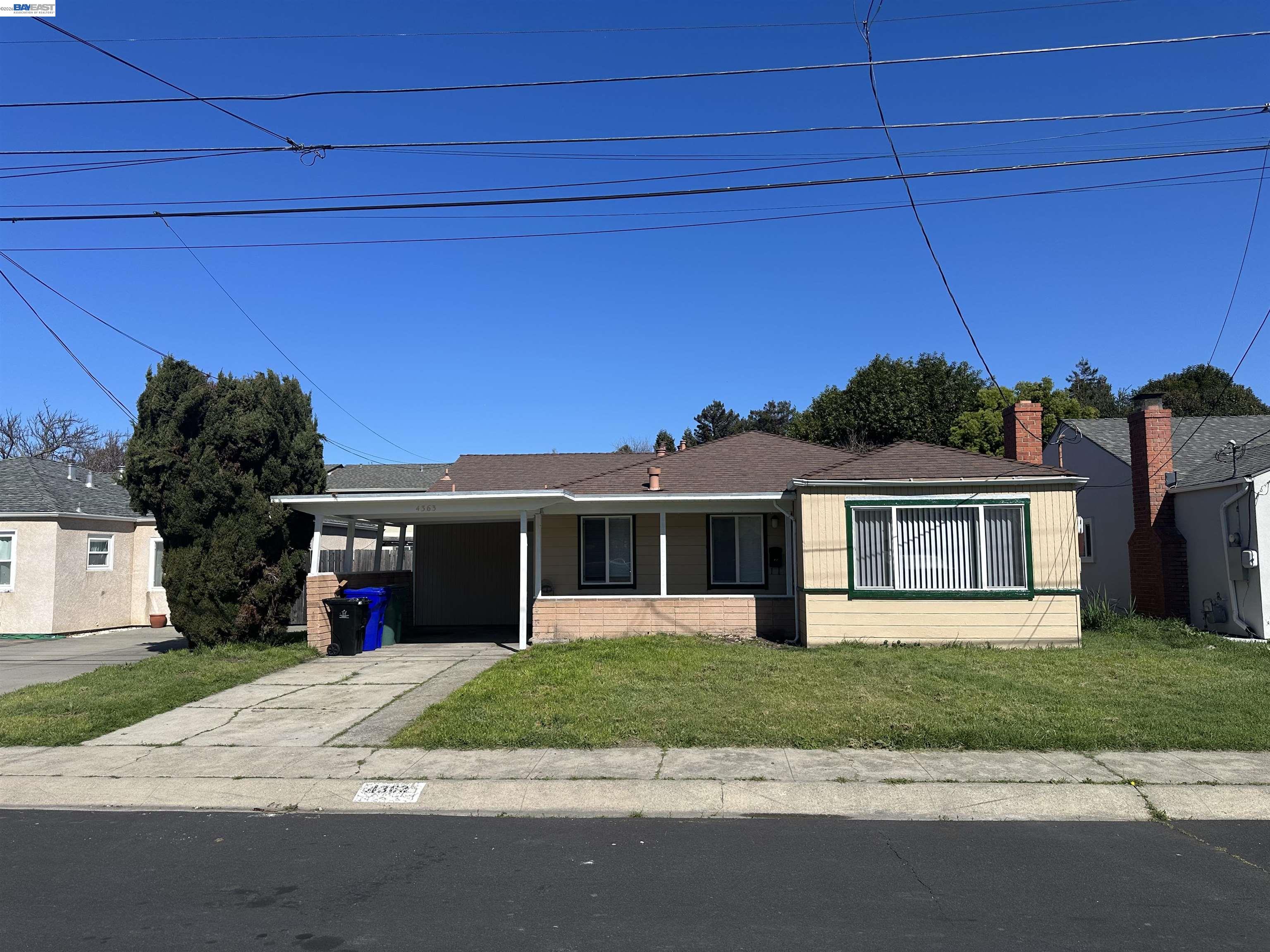 4363 Wesley Way El Sobrante, CA 94803 - Photo 1 of 11 a front view of a house with a yard and garage