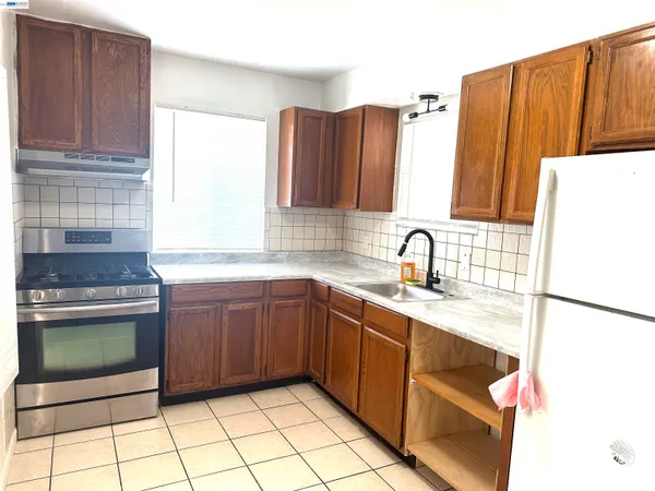 a kitchen with stainless steel appliances granite countertop a sink and a stove