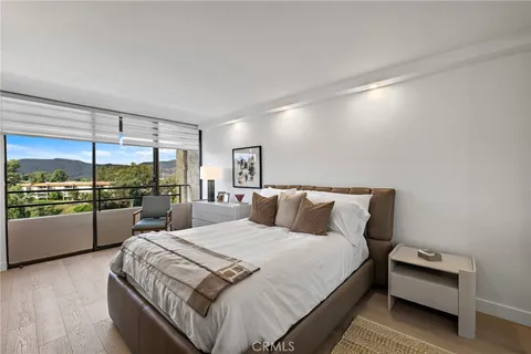 a large bed sitting in a bedroom next to a window