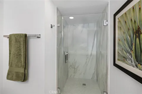 a bedroom with a bed and walk in closet with a large window