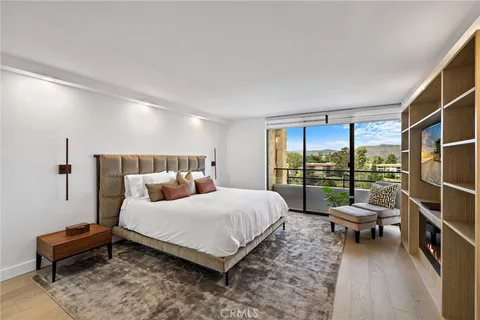 a spacious bedroom with a bed and a television