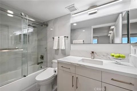 a front view of a building with a garden and plants