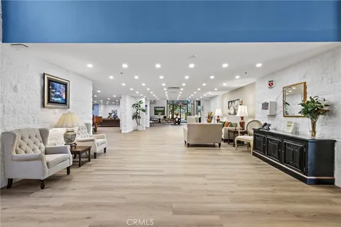 a living room with furniture a fireplace and a table