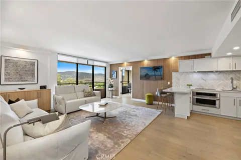 a kitchen with stainless steel appliances granite countertop a sink and a refrigerator