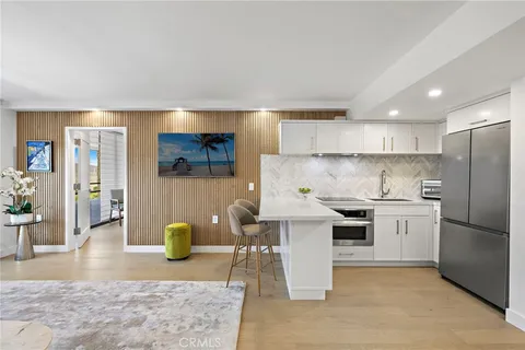 a kitchen with a stove a sink and a refrigerator