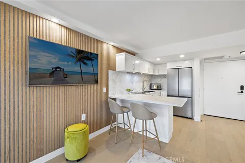 a kitchen with a stove a refrigerator and a table