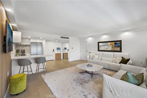 a spacious bedroom with a bed a mirror and lamp