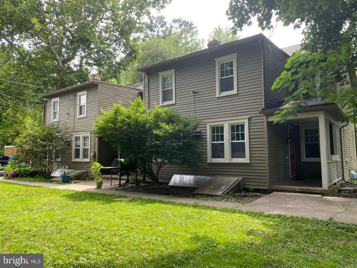 908 Easton Road Riegelsville, PA 18077 - Photo 2 of 43 a backyard of a house with table and chairs and potted plants