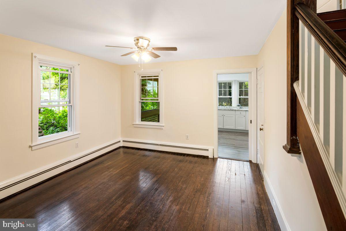 908 Easton Road Riegelsville, PA 18077 - Photo 11 of 43 an empty room with wooden floor fan and windows