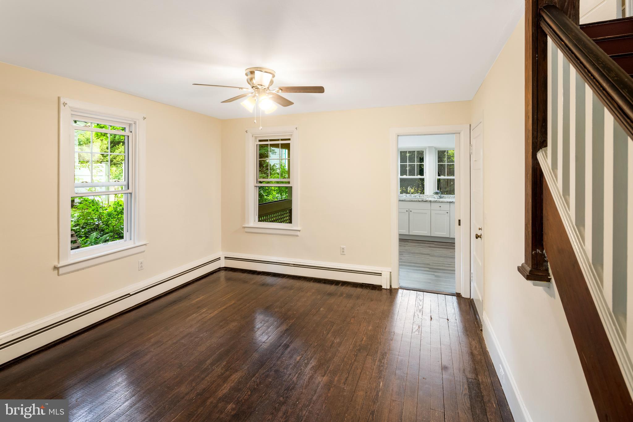 908 Easton Road Riegelsville, PA 18077 - Photo 17 of 43 an empty room with wooden floor fan and windows