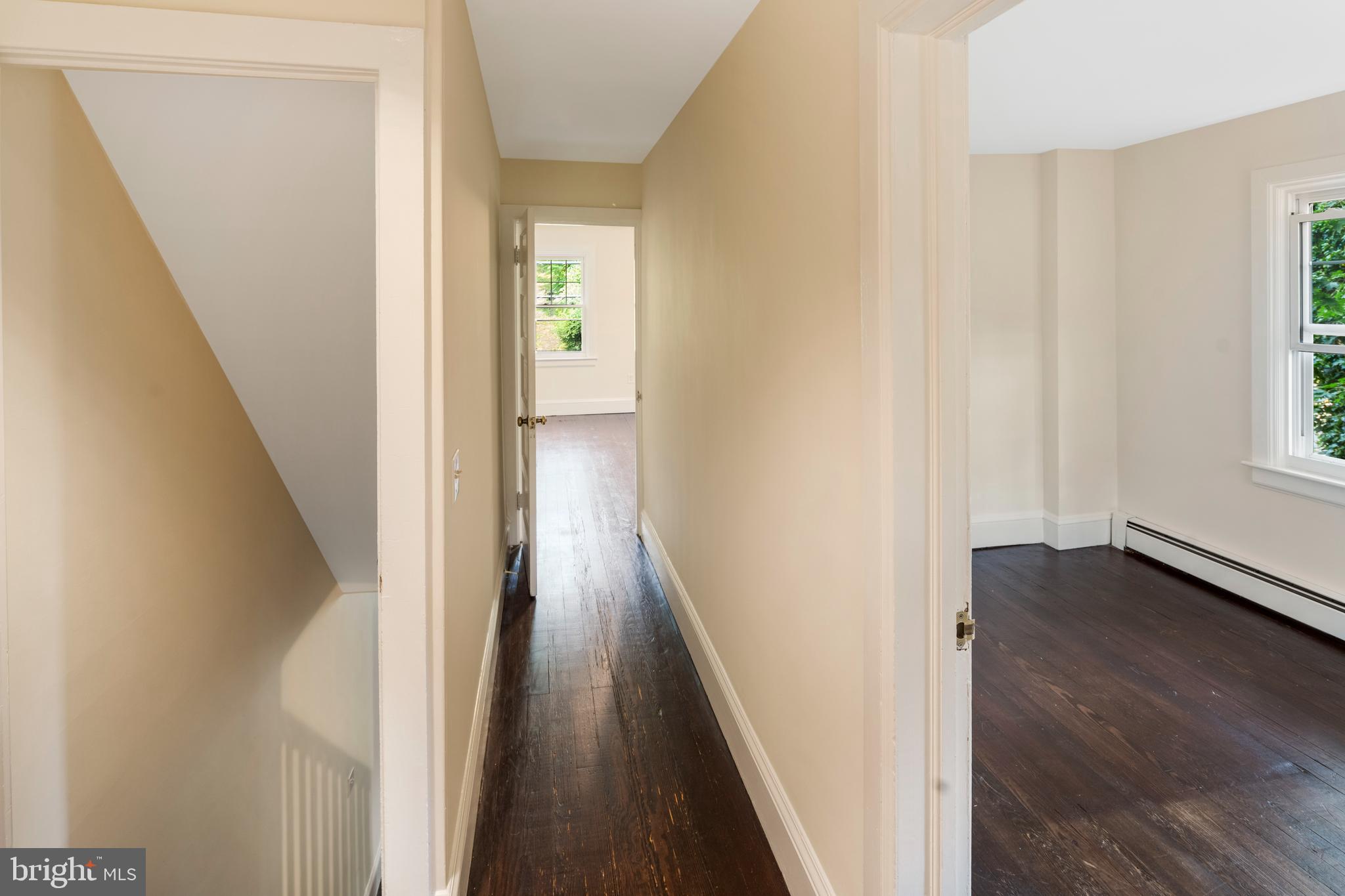 908 Easton Road Riegelsville, PA 18077 - Photo 21 of 43 a view of a hallway with wooden floor and staircase
