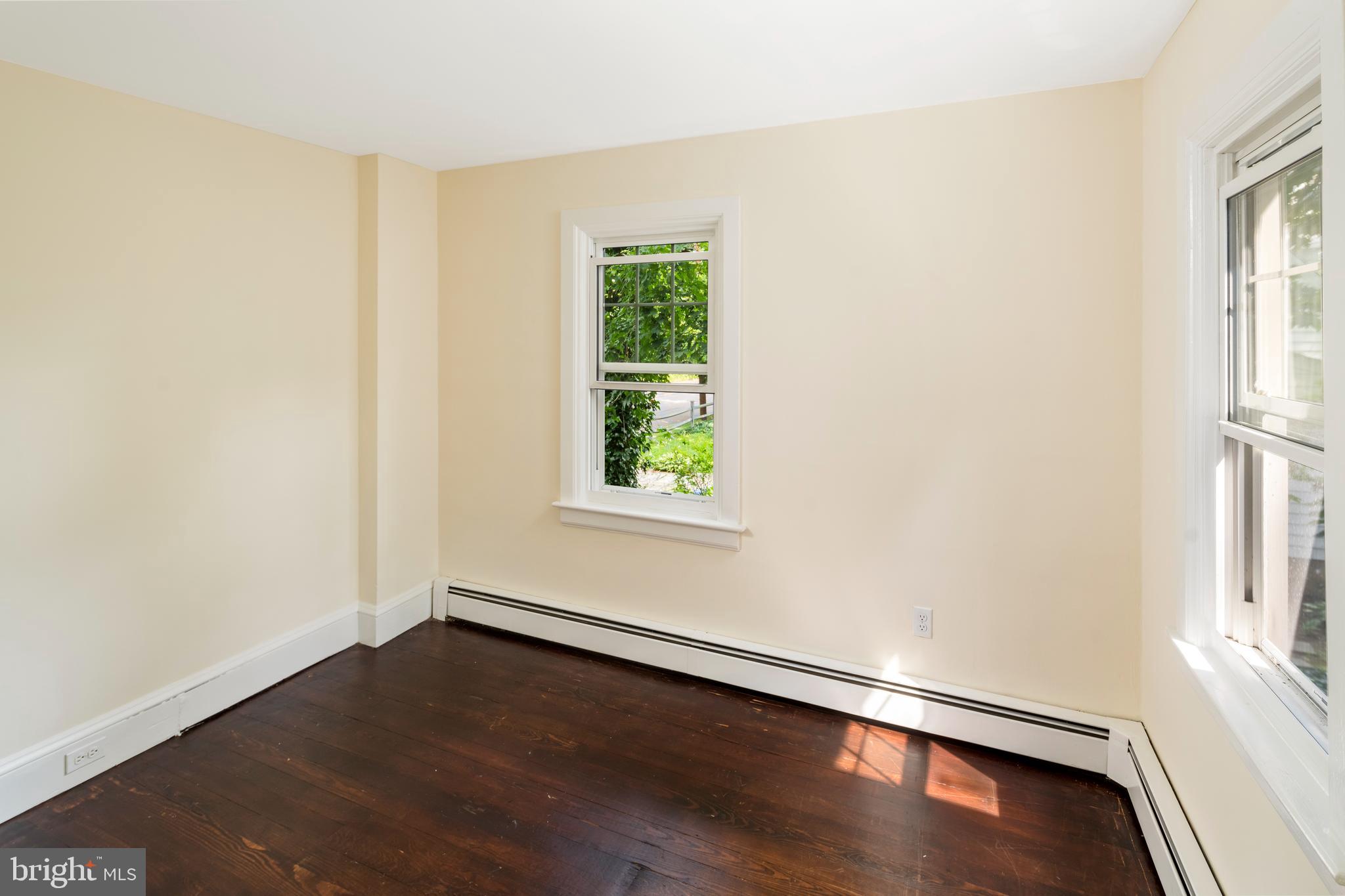 908 Easton Road Riegelsville, PA 18077 - Photo 22 of 43 an empty room with wooden floor and windows