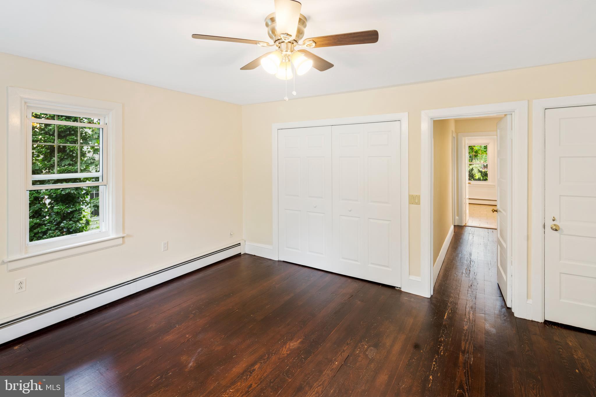 908 Easton Road Riegelsville, PA 18077 - Photo 24 of 43 an empty room with wooden floor chandelier fan and windows