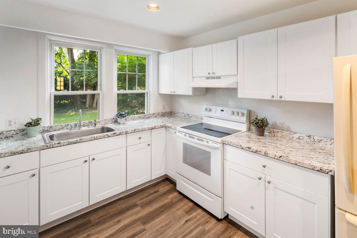 908 Easton Road Riegelsville, PA 18077 - Photo 4 of 43 a kitchen with granite countertop white cabinets and white appliances