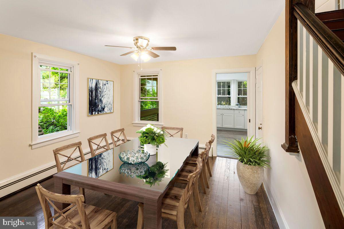 908 Easton Road Riegelsville, PA 18077 - Photo 6 of 43 a dining room with furniture potted plants and wooden floor