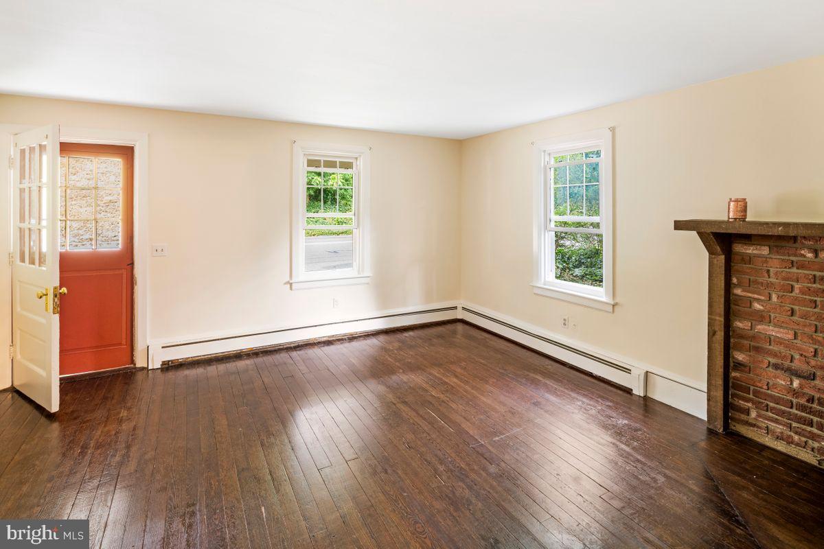 908 Easton Road Riegelsville, PA 18077 - Photo 10 of 43 an empty room with wooden floor and windows