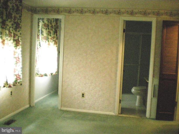 6307 Chesworth Road Catonsville, MD 21228 - Photo 7 of 18 MBR with view of walk-in closet and full bath