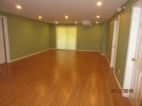 153 Nobscot Road, Unit 153 Sudbury, MA 01776 - Photo 13 of 18 an empty room with wooden floor and windows