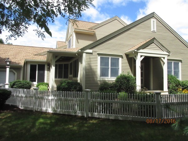 153 Nobscot Road, Unit 153 Sudbury, MA 01776 - Photo 15 of 18 a front view of a house with a garden and plants