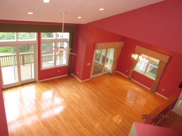 153 Nobscot Road, Unit 153 Sudbury, MA 01776 - Photo 8 of 18 a view of an empty room with a window and a kitchen