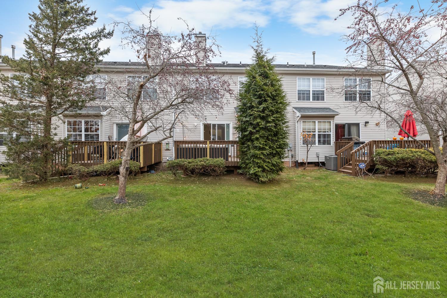 7 Edith Drive Somerset, NJ 08873 - Photo 32 of 49 a white house that has a big yard and a more seating