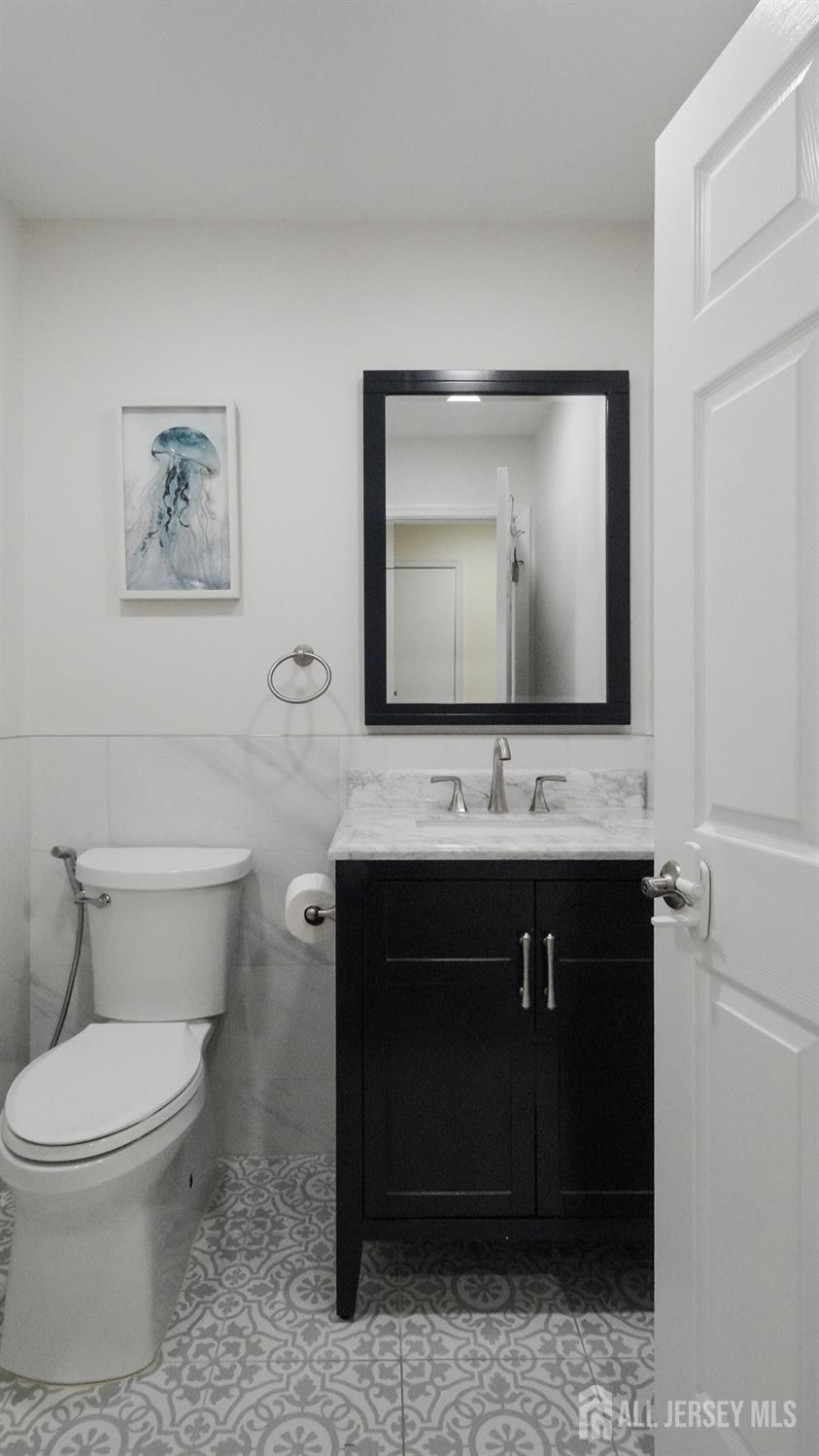 7 Edith Drive Somerset, NJ 08873 - Photo 39 of 49 a bathroom with a toilet a sink and mirror