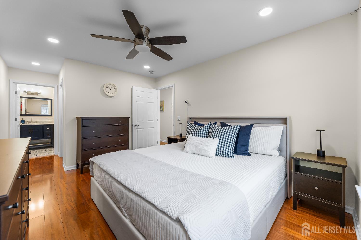 7 Edith Drive Somerset, NJ 08873 - Photo 42 of 49 a bedroom with a bed and a flat tv screen on dresser
