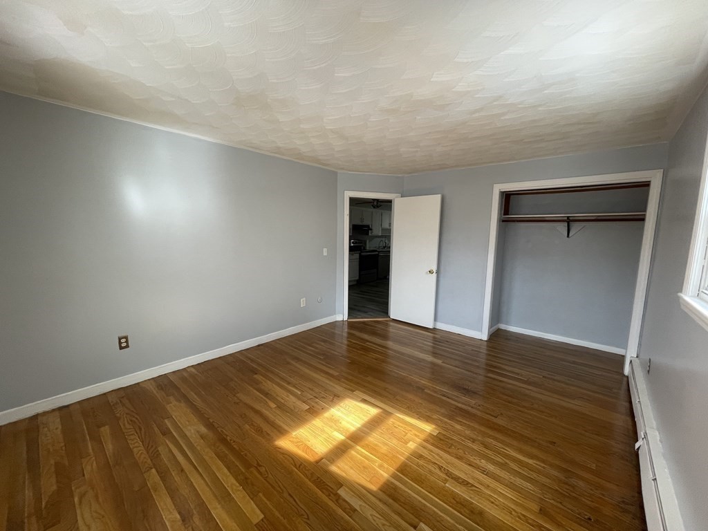 72 Longfellow Road Worcester, MA 01602 - Photo 12 of 36 wooden floor in an empty room with a window