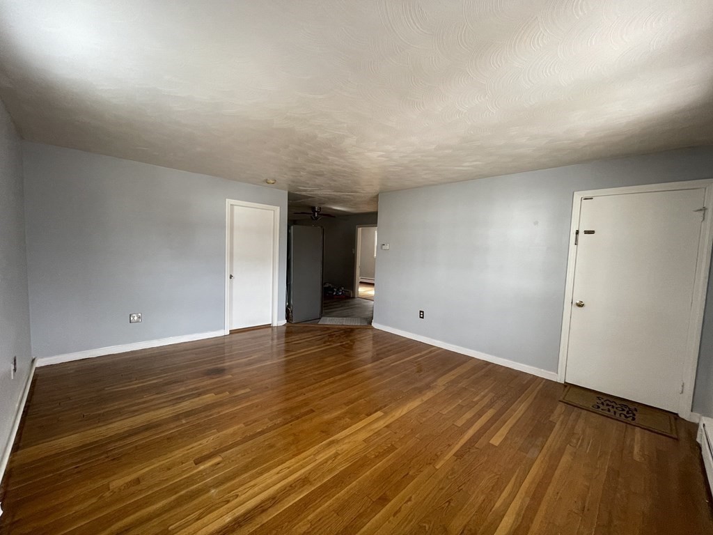 72 Longfellow Road Worcester, MA 01602 - Photo 13 of 36 a view of an empty room and wooden floor