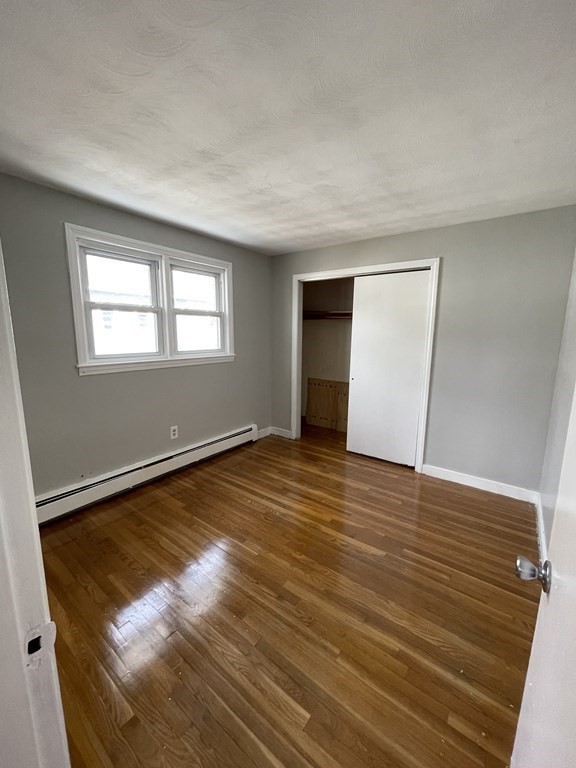 72 Longfellow Road Worcester, MA 01602 - Photo 14 of 36 an empty room with wooden floor and windows