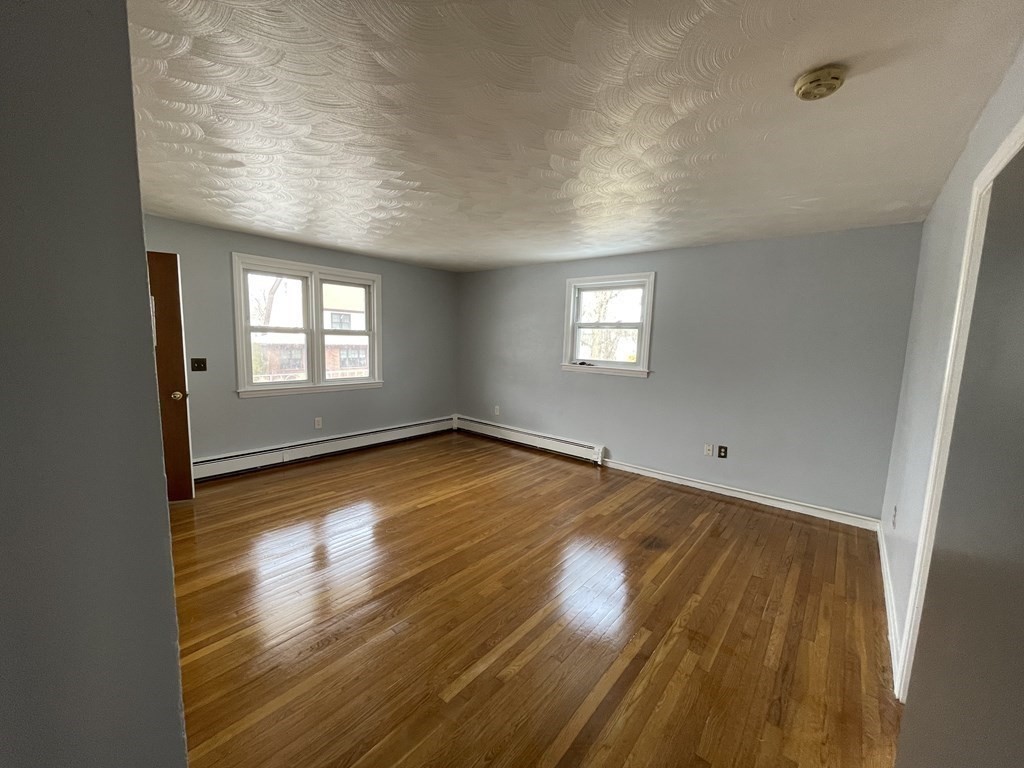 72 Longfellow Road Worcester, MA 01602 - Photo 16 of 36 an empty room with wooden floor and windows