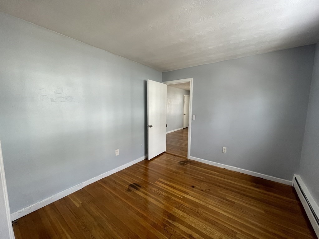 72 Longfellow Road Worcester, MA 01602 - Photo 17 of 36 a view of an empty room with wooden floor