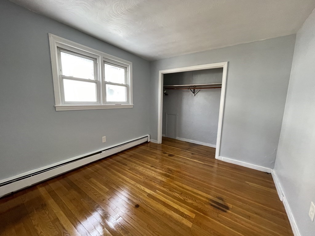 72 Longfellow Road Worcester, MA 01602 - Photo 18 of 36 a view of an empty room with wooden floor and a window