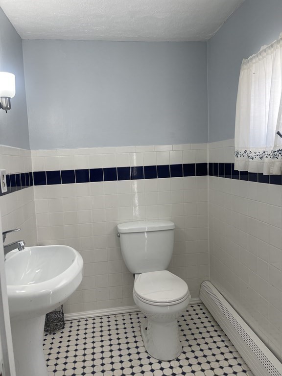 72 Longfellow Road Worcester, MA 01602 - Photo 28 of 36 a bathroom with a toilet a sink and a mirror