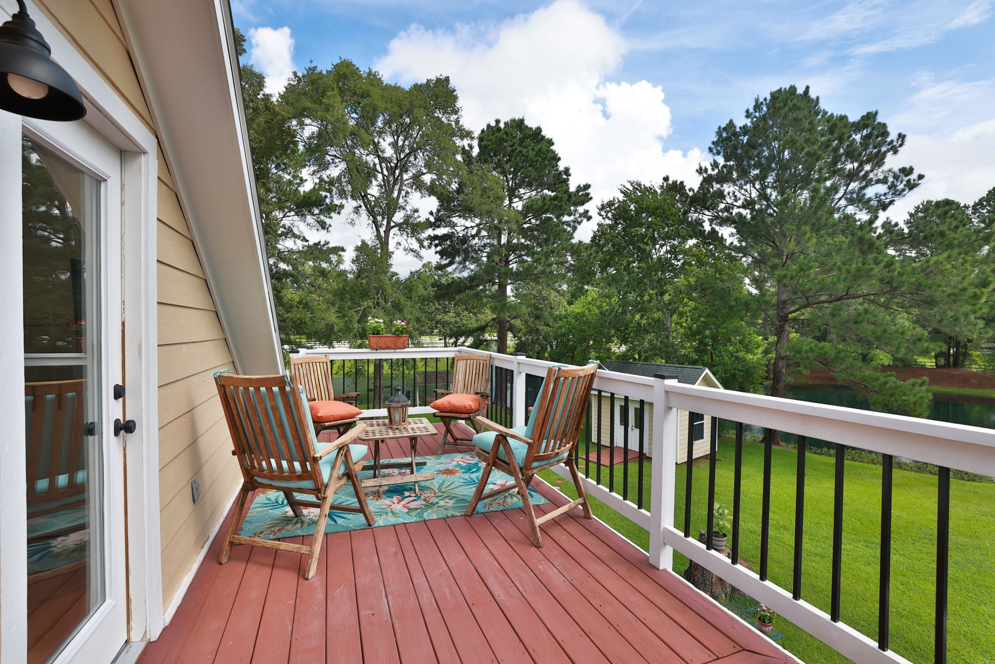 34310 High Point Drive Magnolia, TX 77355 - Photo 33 of 48 This inviting balcony features a cozy seating area and the most stunning views of the property. So serene and perfect for relaxing outdoors.