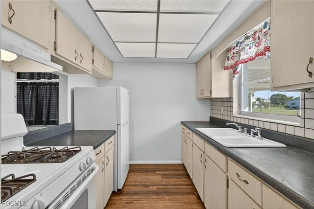 a kitchen with stainless steel appliances granite countertop a sink stove and cabinets