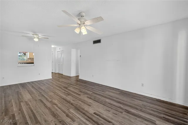 a view of an empty room and wooden floor