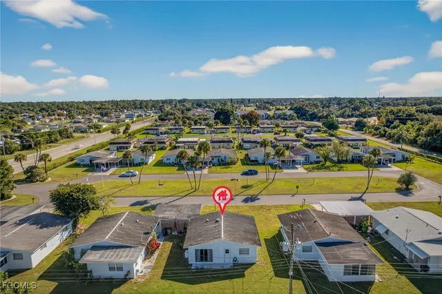 an aerial view of a houses with a swimming pool