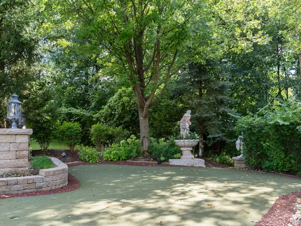 a view of a bench in the garden near a lake