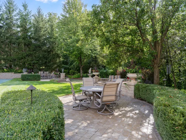 a view of a house with potted plants and a yard