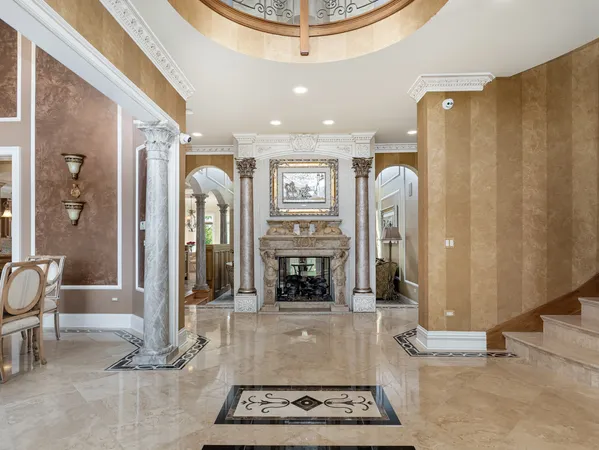 a dining room with furniture a chandelier and wooden floor
